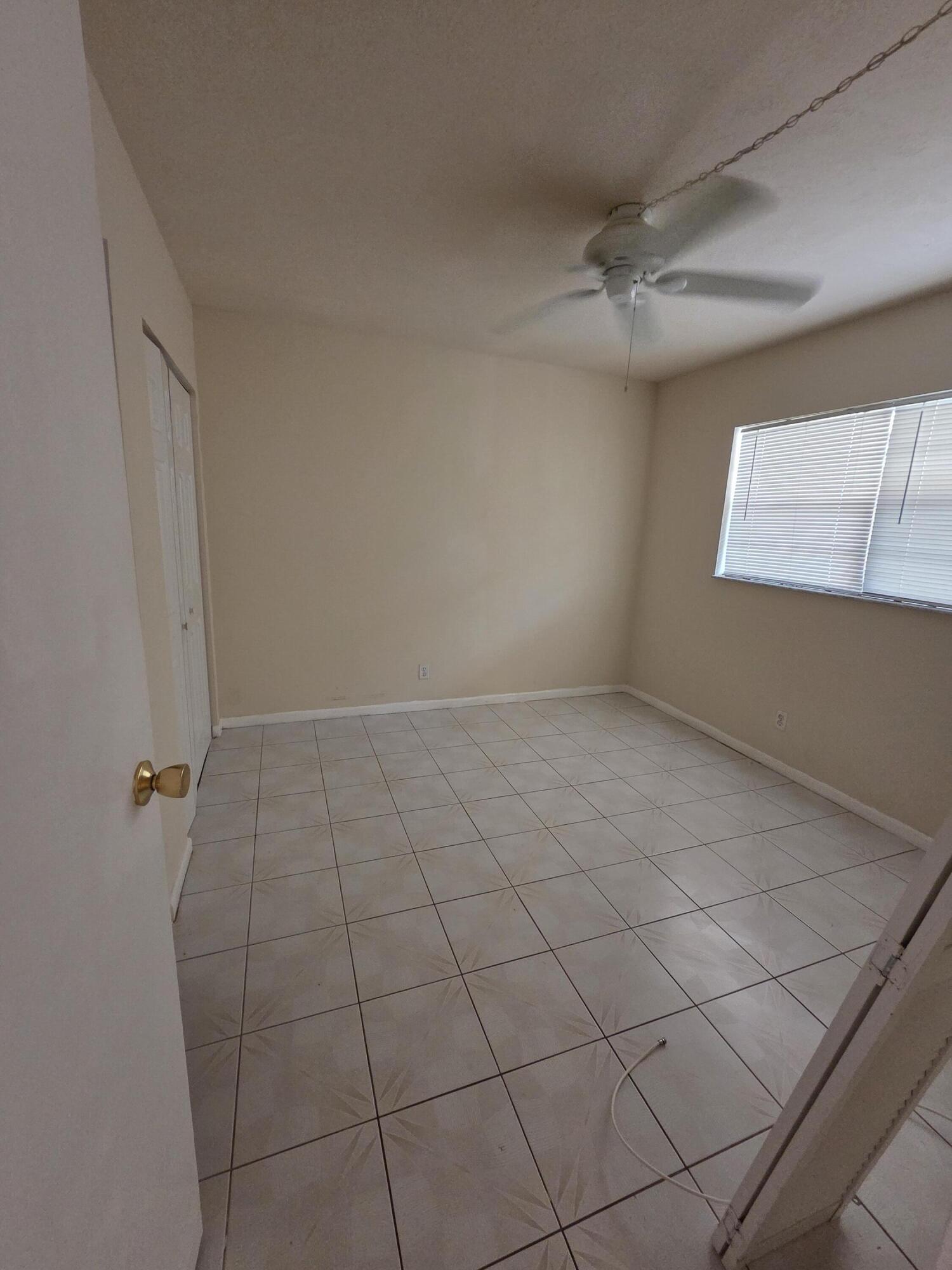 14790 Bonaire Boulevard, Unit 104 Delray Beach, FL 33446 - Photo 10 of 12 a view of a room with racks on the wall