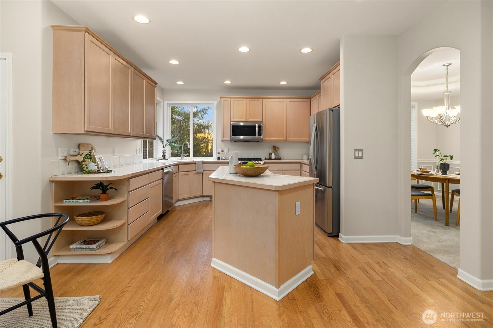 1402 Langara Circle Bellingham, WA 98229 - Photo 16 of 40 a kitchen with a sink a counter top space stainless steel appliances and cabinets