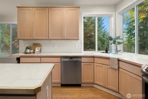 a kitchen with a sink and large window