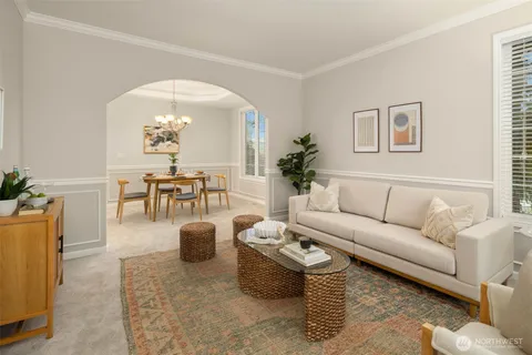 a living room with furniture a rug and a chandelier