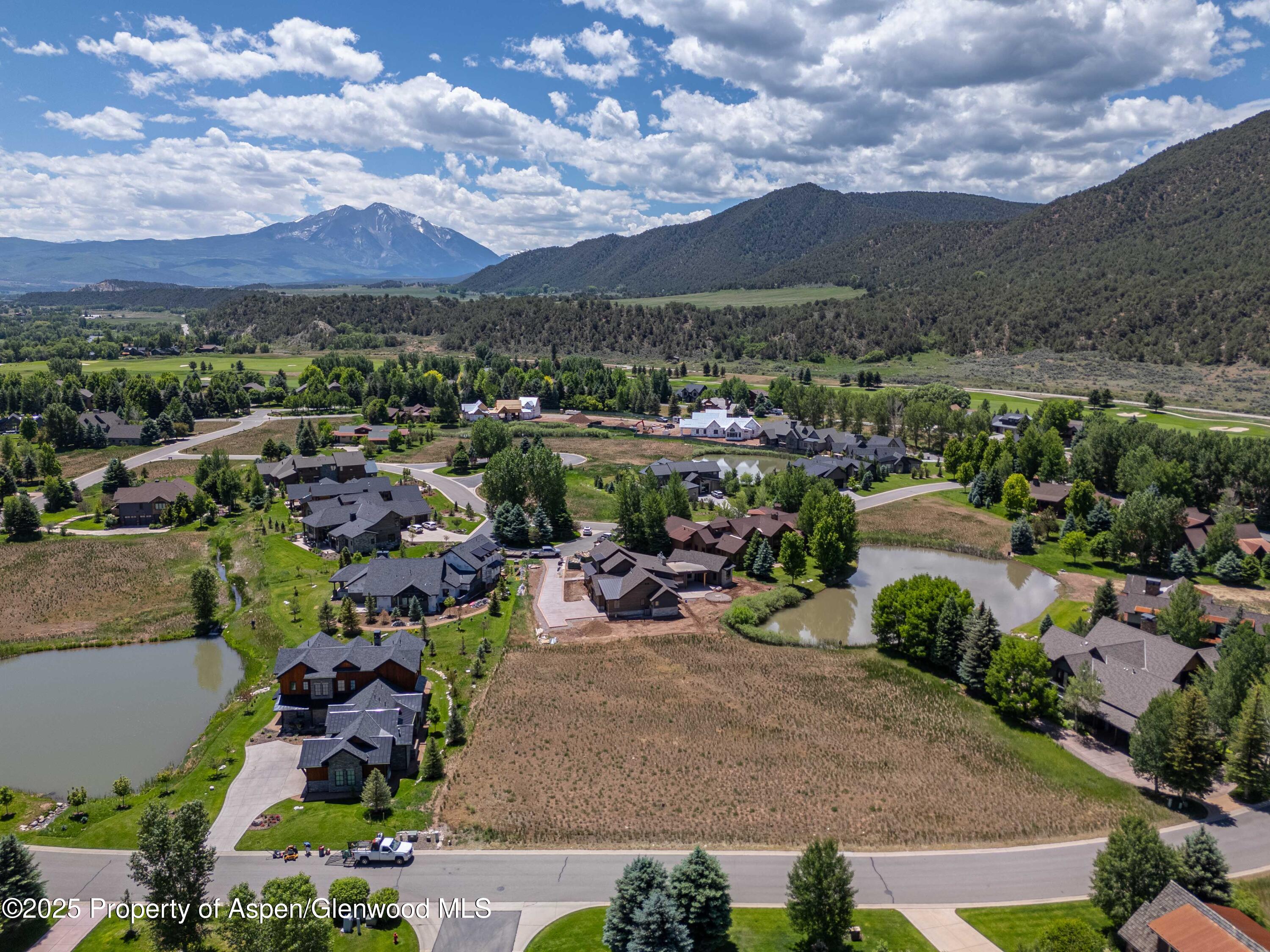 an aerial view of a houses with yard