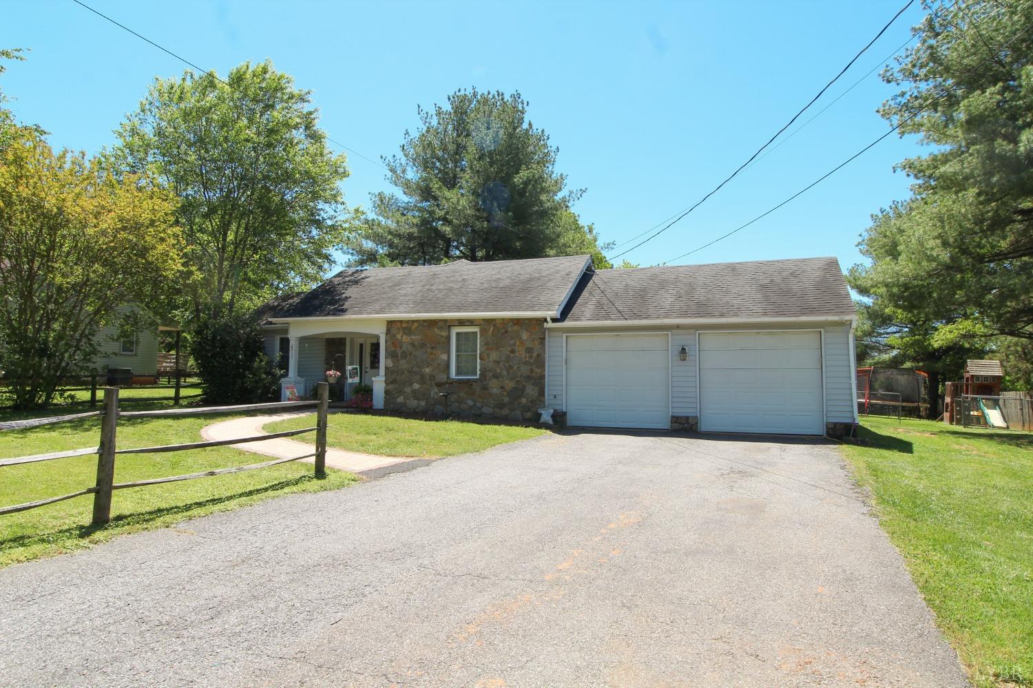 1217 Wood Road Lynchburg, VA 24502 - Photo 1 of 29 a front view of house with yard and trees in the background