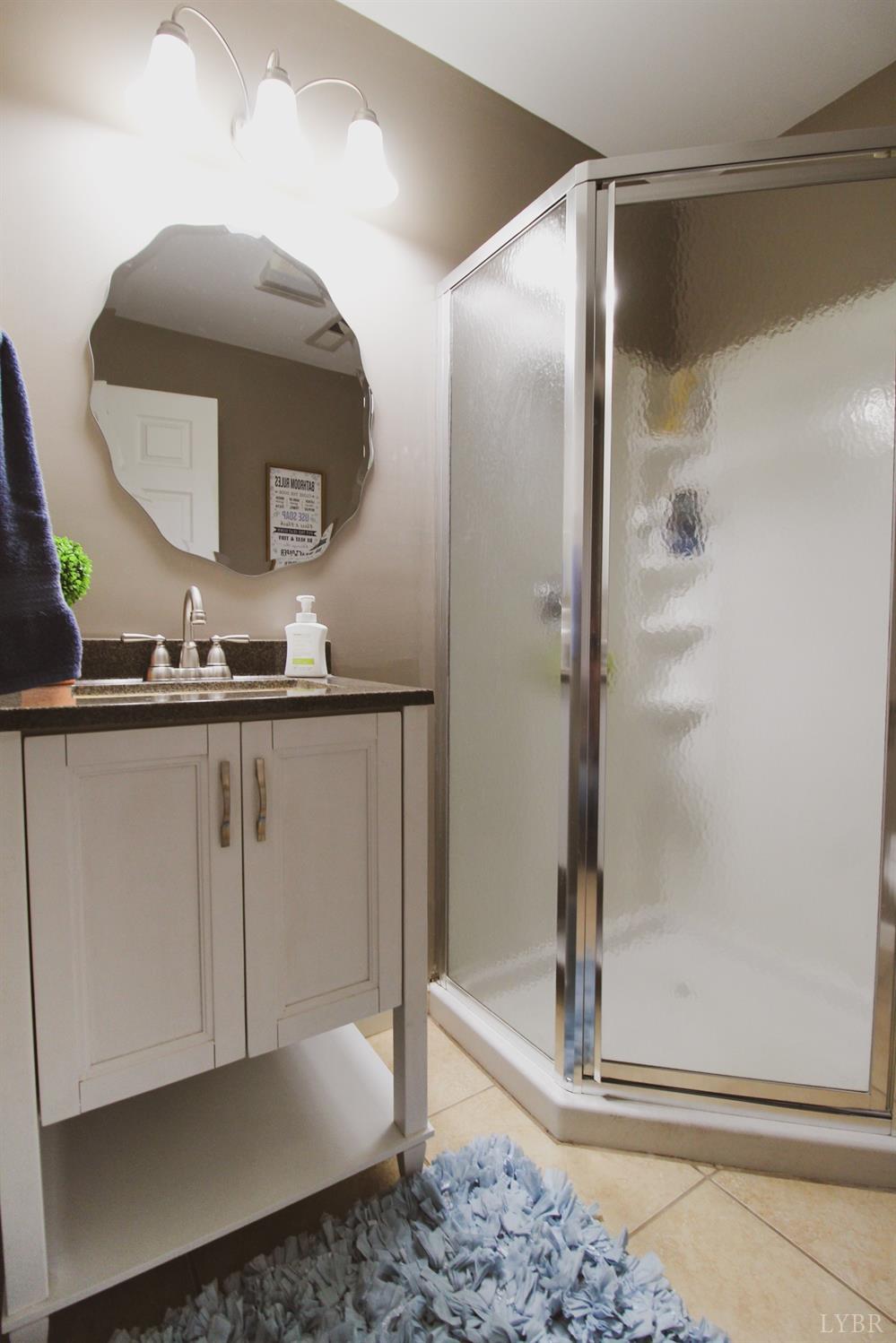 1217 Wood Road Lynchburg, VA 24502 - Photo 14 of 29 a bathroom with a mirror sink and vanity