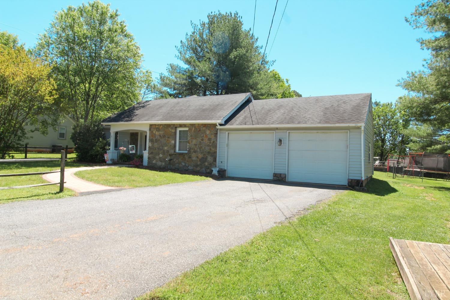 1217 Wood Road Lynchburg, VA 24502 - Photo 4 of 29 a house with huge green field in front of it
