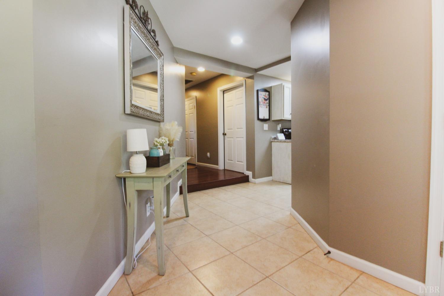 1217 Wood Road Lynchburg, VA 24502 - Photo 5 of 29 an empty room with wooden floor and a bathroom