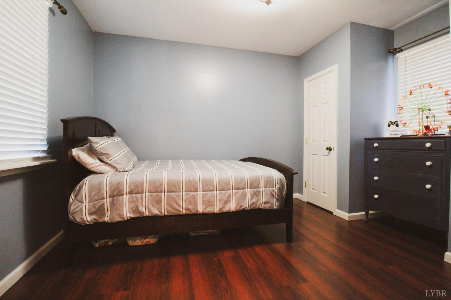 1217 Wood Road Lynchburg, VA 24502 - Photo 9 of 29 a bed sitting in a bedroom next to a window