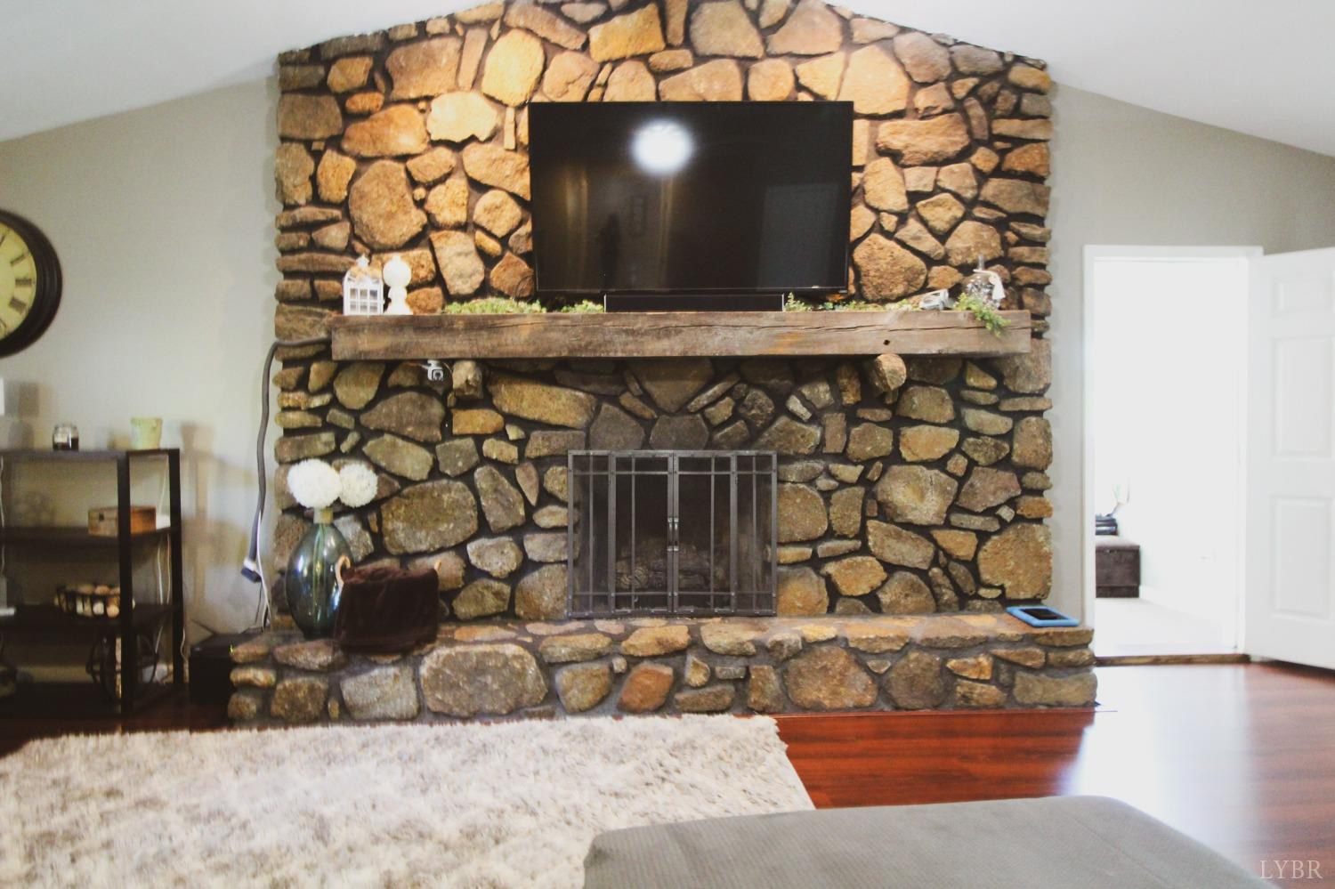 1217 Wood Road Lynchburg, VA 24502 - Photo 10 of 29 a living room with a couch and a chandelier
