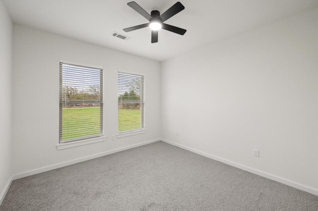 6771 Northwest County Road 1146 Barry, TX 75102 - Photo 26 of 34 an empty room with a window and a ceiling fan