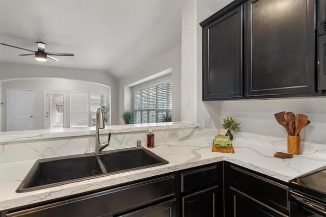 a kitchen with a sink and cabinets