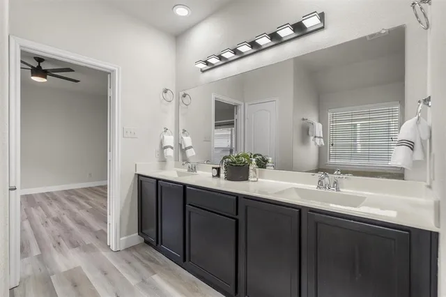 a bathroom with a double vanity sink and a mirror