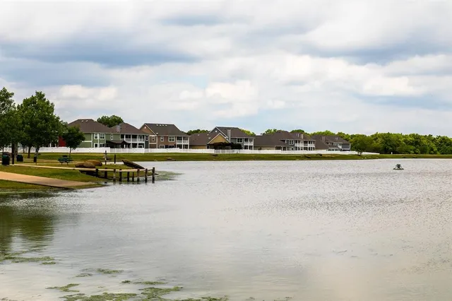 a swimming pool with lots of tress in the background