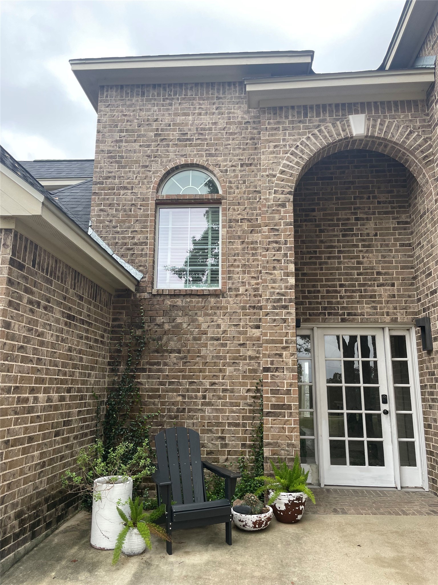 329 Flash Circle Luling, TX 78648 - Photo 32 of 32 An arched brick entryway guides visitors to a classic multi-lite glass front door.