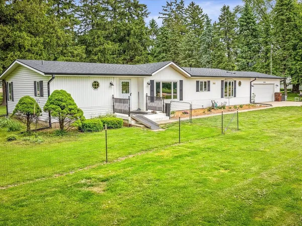 a view of a house with a yard and sitting area