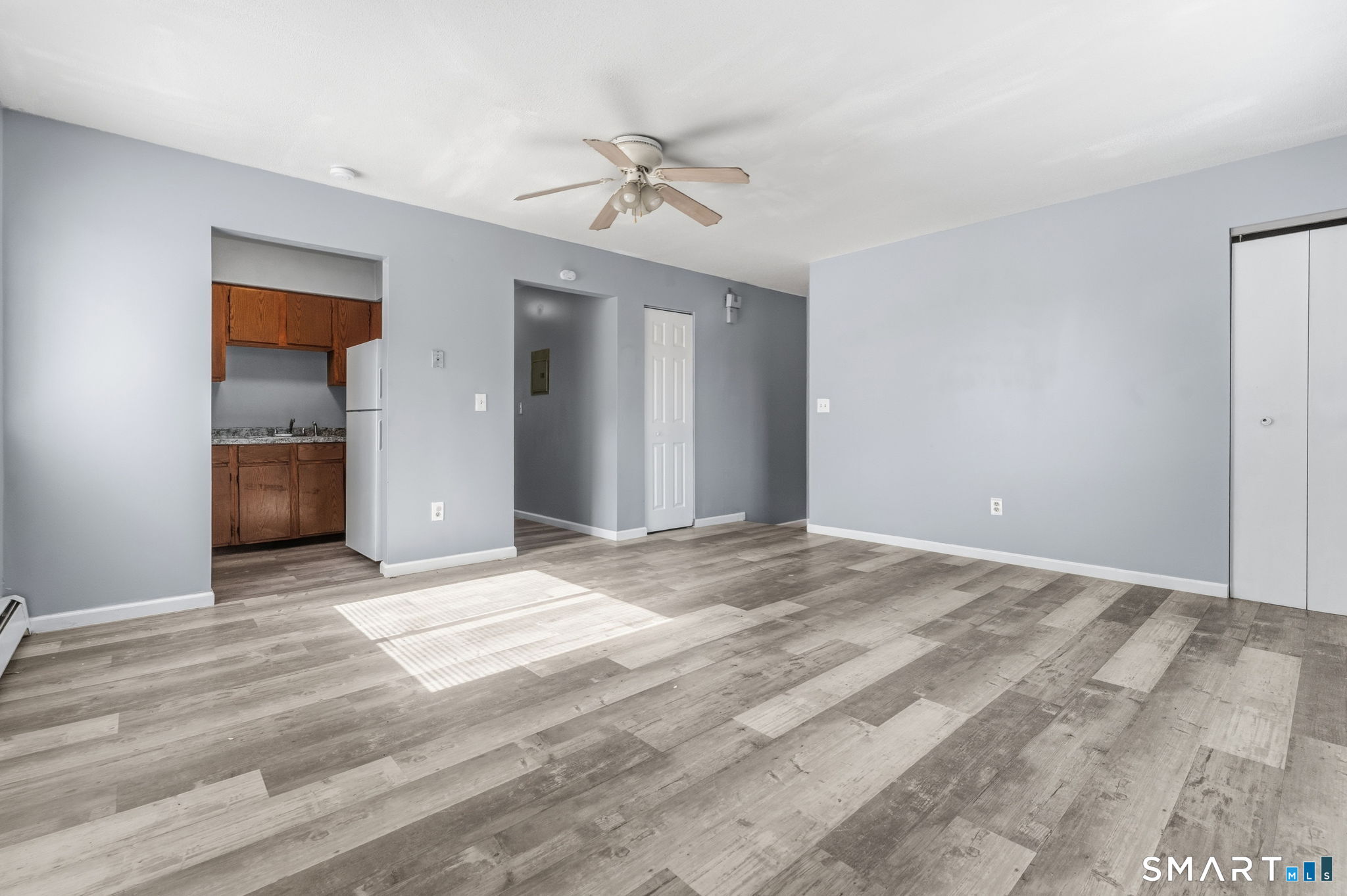 5-7 Warner St Extension, Unit 5B Hartford, CT 06114 - Photo 4 of 17 a view of an empty room with a ceiling fan