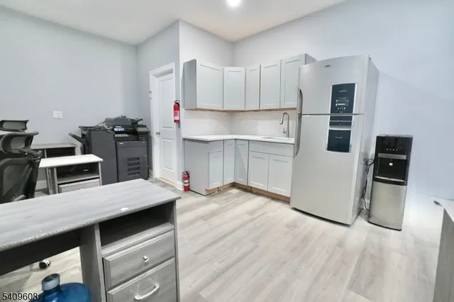 a kitchen with a refrigerator and a stove top oven