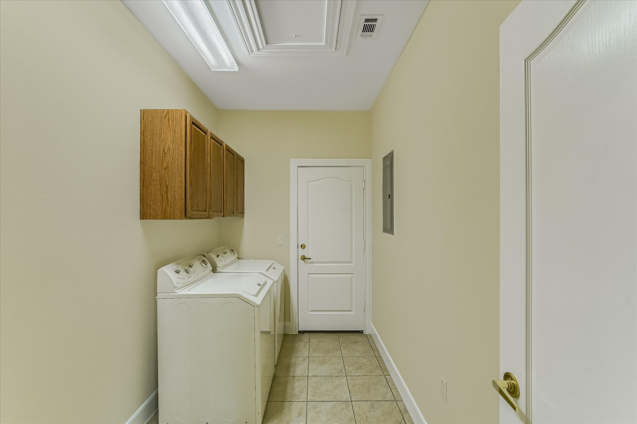 603 Rio Grande Loop Georgetown, TX 78633 - Photo 11 of 27 Washroom with cabinet space, light tile patterned floors, washer and dryer, and attic access
