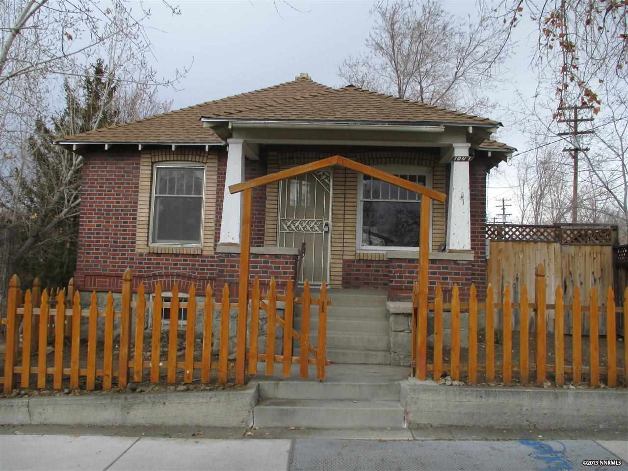 1047 West 1st Street Reno, NV 89503 - Photo 1 of 1 a front view of a house with a fence