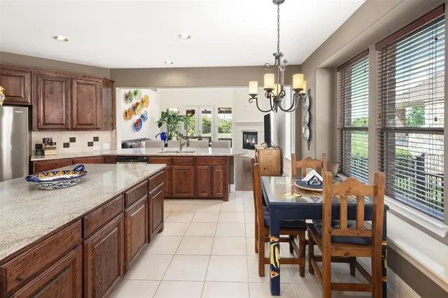 a kitchen with stainless steel appliances granite countertop counter space a sink cabinets and a window