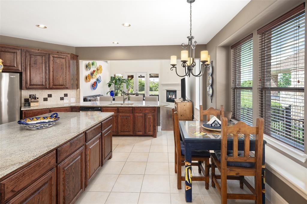 2801 Meadow Ridge Drive Prosper, TX 75078 - Photo 12 of 40 a kitchen with stainless steel appliances granite countertop counter space a sink cabinets and a window