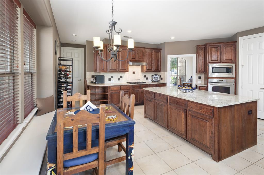 2801 Meadow Ridge Drive Prosper, TX 75078 - Photo 14 of 40 a large kitchen with a table and chairs