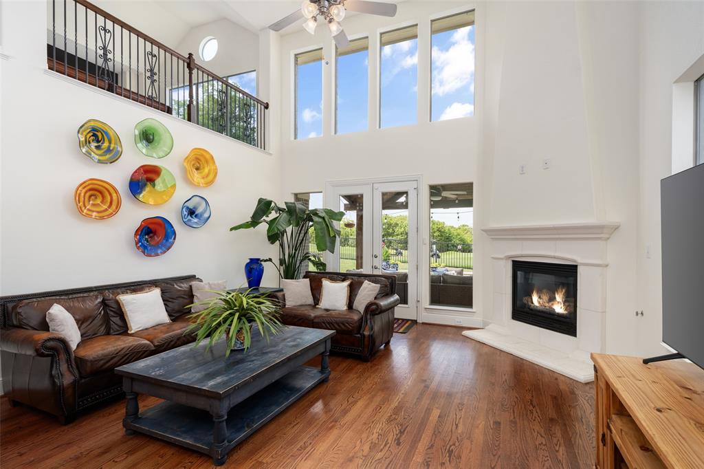 2801 Meadow Ridge Drive Prosper, TX 75078 - Photo 16 of 40 a living room with furniture and a fireplace