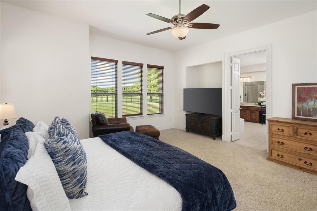 2801 Meadow Ridge Drive Prosper, TX 75078 - Photo 20 of 40 a spacious bedroom with a large bed and a window