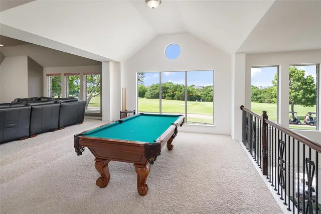a room with pool table and windows