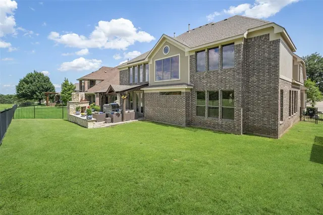 a backyard of a house with a garden and barbeque oven