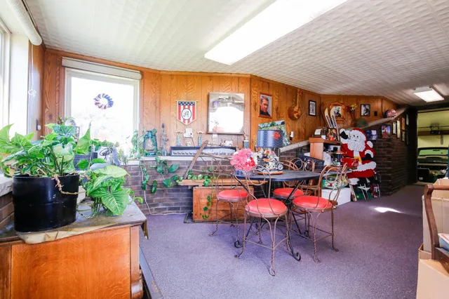 an outdoor living room with furniture and a floor to ceiling window