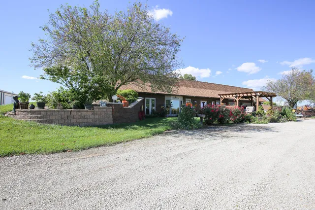 a view of a house with garden and pathway