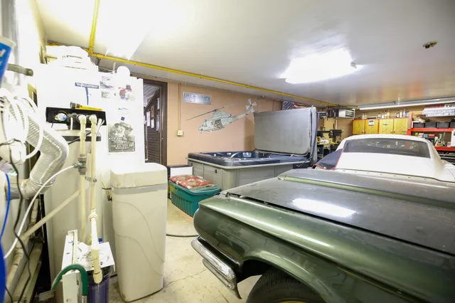 a bedroom with a bed gym equipment and view of living room