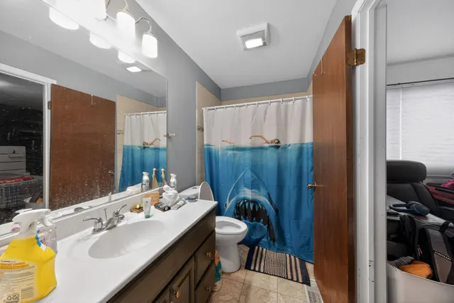 a bathroom with a sink vanity granite and a mirror