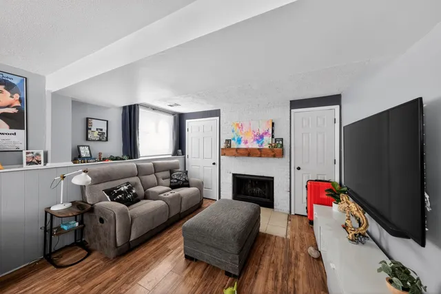 a living room with furniture flat screen tv and a fireplace