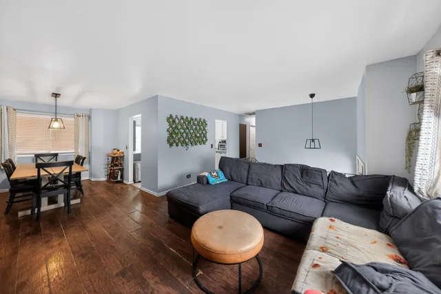 a living room with furniture a wooden floor and a window