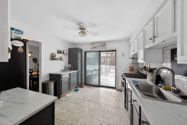 a kitchen with a sink stove and refrigerator