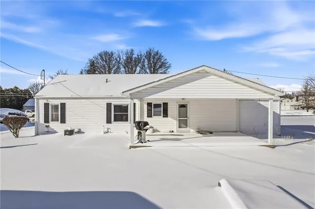 a patio with a table and chairs under an umbrella