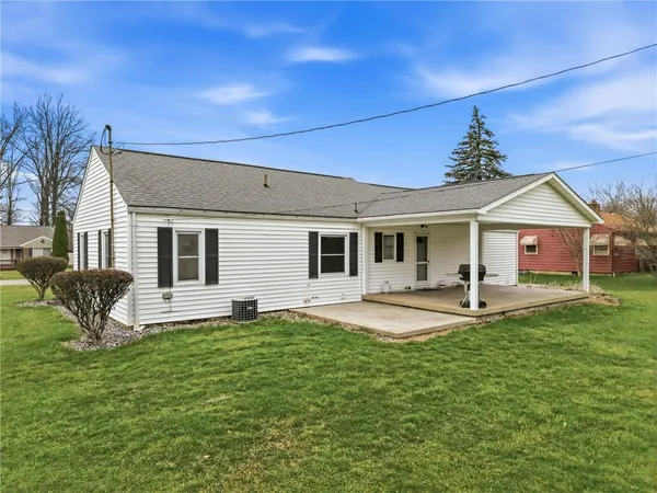 a front view of a house with a garden and yard