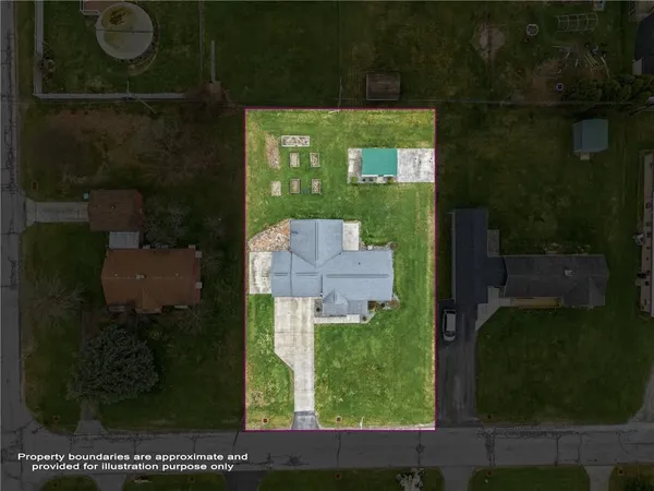 an aerial view of a residential houses with outdoor space and garden