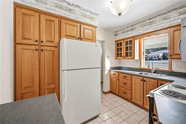 a white refrigerator freezer sitting inside of a kitchen