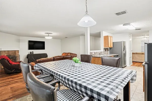 a large kitchen with a table and chairs