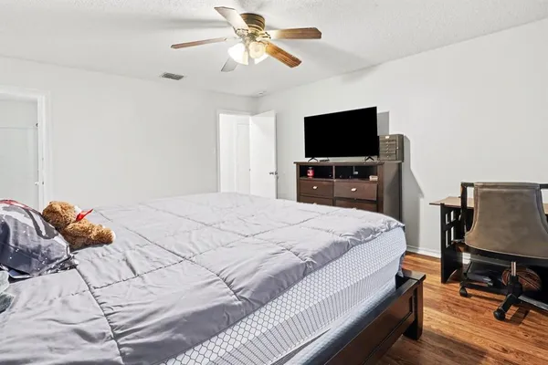 a bedroom with a bed and a flat screen tv