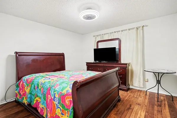 a bedroom with a bed and a flat screen tv