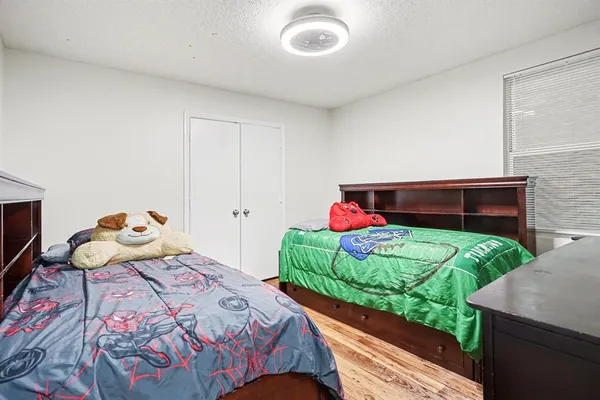 a bedroom with a bed and a dresser