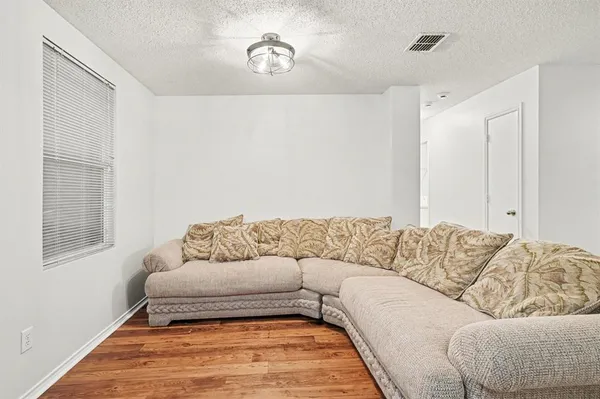 a living room with a couch and a dresser