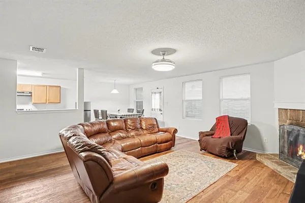a living room with furniture ceiling fan and a wooden floor