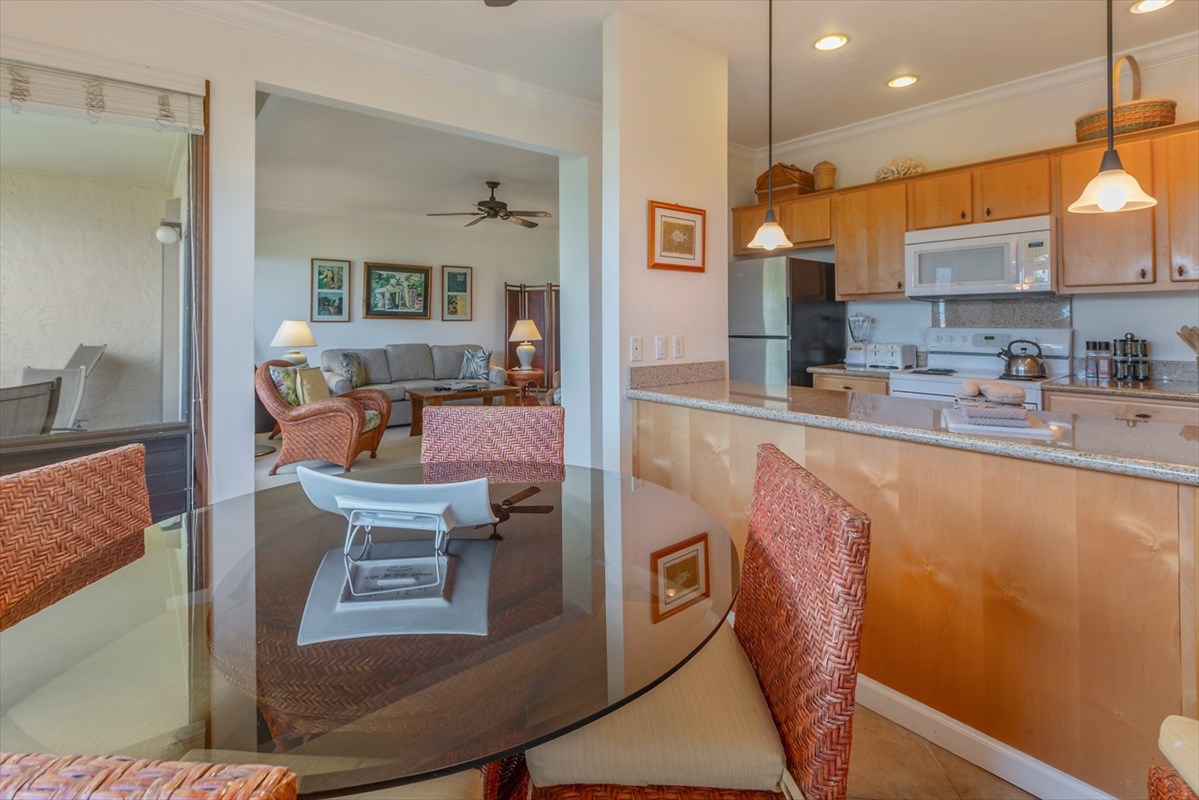 1901 Poipu Road, Unit 213 Koloa, HI 96756 - Photo 7 of 15 a kitchen with stainless steel appliances granite countertop a sink and a refrigerator
