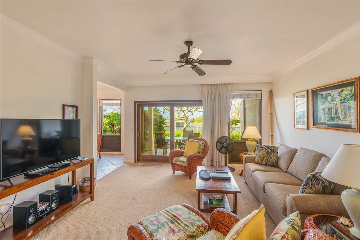 1901 Poipu Road, Unit 213 Koloa, HI 96756 - Photo 8 of 15 a living room with furniture a flat screen tv and a large window