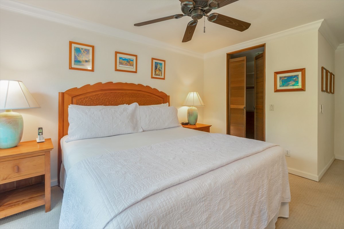 1901 Poipu Road, Unit 213 Koloa, HI 96756 - Photo 10 of 15 a bedroom with a bed and a chandelier