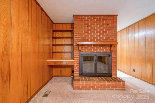 a room with a fireplace and window