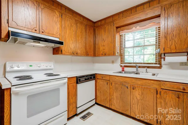 a kitchen with granite countertop cabinets stainless steel appliances and a sink